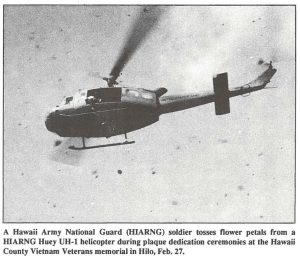 A Hawaii Army National Guard (HIARNG) soldier tosses flower petals from a HARNG Huey UH-1 helicopter during plaque dedication ceremonies at the Hawaii County Vietnam Veterans memorial in Hilo, Feb. 27.