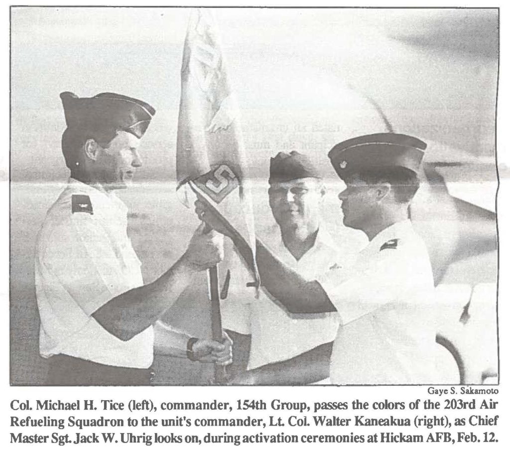 CoL Michael H. Tice (left), commander, 154th Group, passes the colors of the 203rd Air Refueling Squadron to the unit's commander, Lt Col. Walter Kaneakua (right), as Chief Master Sgt. Jack W. Uhrig looks on, during activation ceremonies at Hickam AFB, Feb. 12.