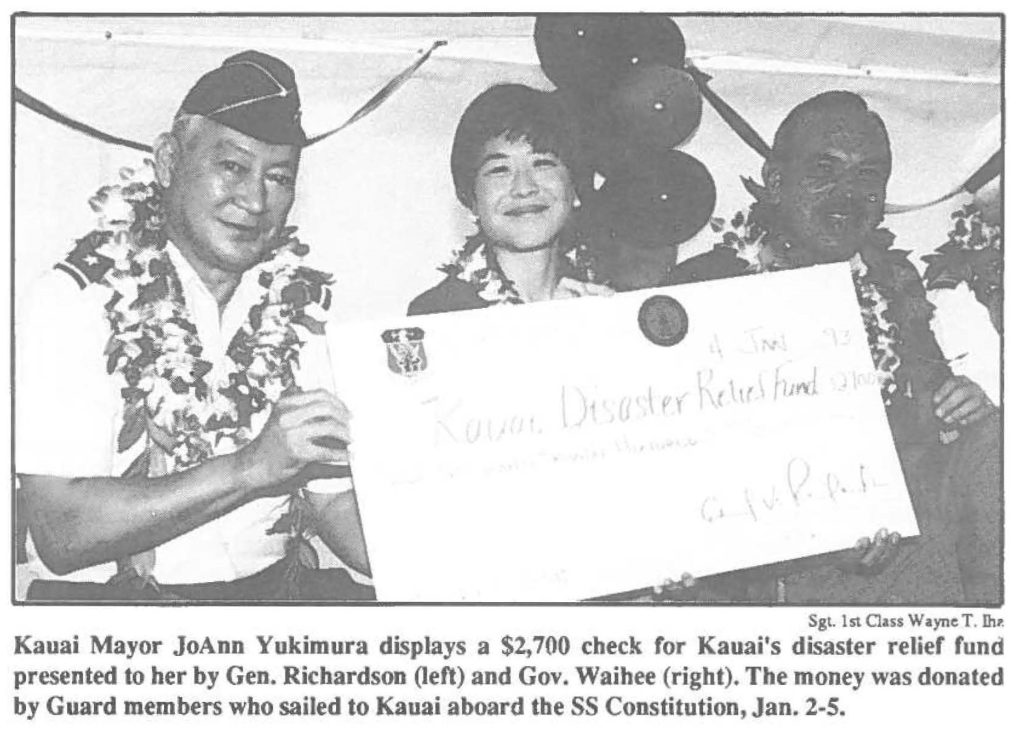 Kauai Mayor JoAnn Yukimura displays a $2,700 check for Kauai's disaster relief fund presented lo her by Gen. Richardson (left) and Gov. Waihee (right). The money was donated by Guard members who sailed to Kauai aboard the SS Constitution, Jan. 2-5.