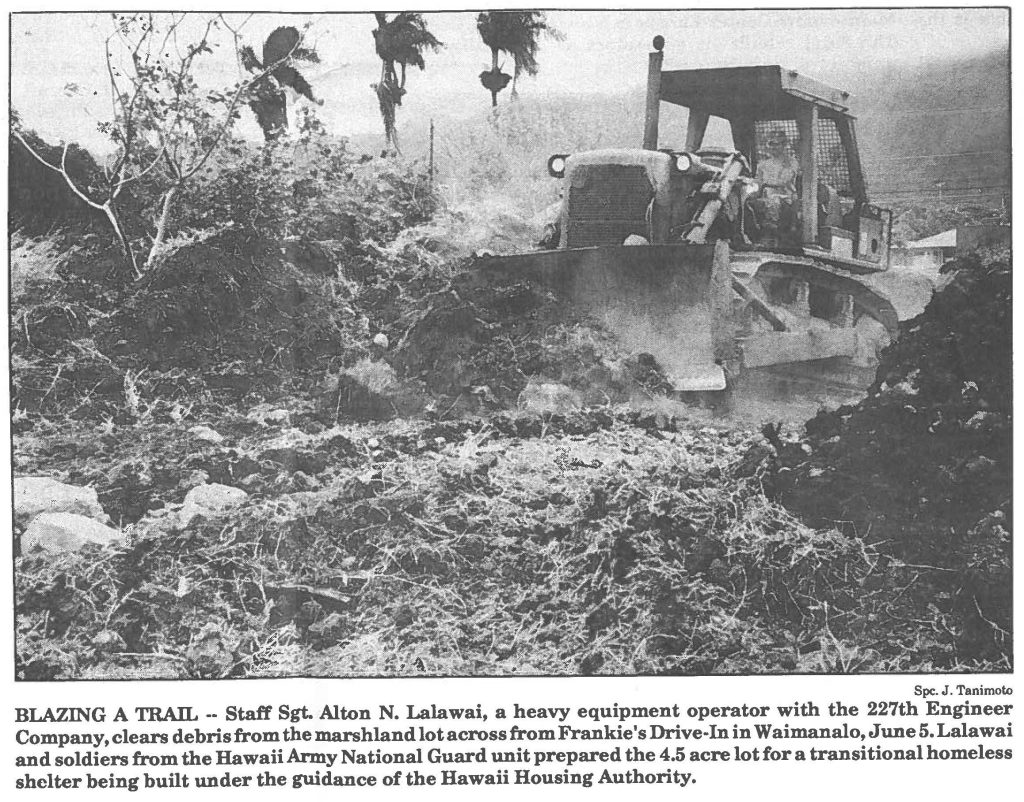 BLAZING A TRAIL -- Staff Sgt. Alton N. Lalawai, a heavy equipment operator with the 227th Engineer Company, clears debris from the marshland lot across from Frankie's Drive-In in Waimanalo, June 5. Lalawai and soldiers from the Hawaii Army National Guard unit prepared the 4.5 acre lot for a transitional homeless shelter being built under the guidance of the Hawaii Housing Authority.