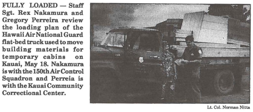 FULLY LOADED - Staff Sgt. Rex Nakamura and Gregory Perreira review the loading plan of the Hawaii Air National Guard flat-bed truck used to move building materials for temporary cabins on Kauai, May 18. Nakamura is with the 150th Air Control Squadron and Perreia is with the Kauai Community Correctional Center.