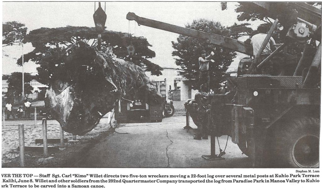 OVER THE TOP - Staff Sgt. Carl "Kimo" Willet directs two five-ton wreckers moving a 22-foot log over several metal posts at Kuhio Park Terrace Kalihi, June 8. Willet and other soldiers from the 292nd Quartermaster Company transported the log from Paradise Park in Manoa Valley to Kuhio Park Terrace to be carved into a Samoan canoe.