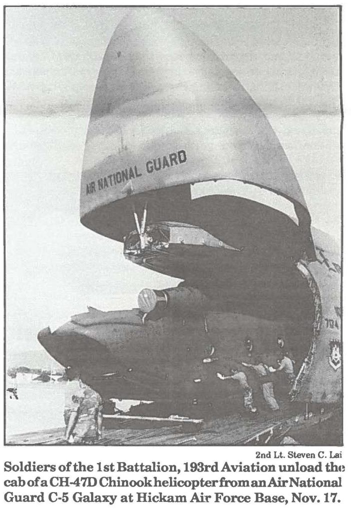 Soldiers of the 1st Battalion, 193rd Aviation unload the cab of a CH-47D Chinook helicopter from an Air National Guard C-5 Galaxy at Hickam Air Force Base, Nov. 17.