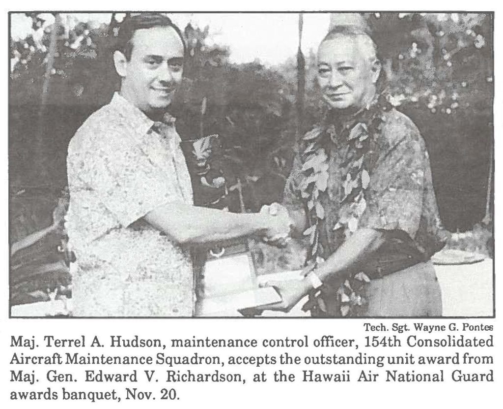 Maj. Terrel A. Hudson, maintenance control officer, 154th Consolidated Aircraft Maintenance Squadron, accepts the outstanding unit award from Maj. Gen. Edward V. Richardson, at the Hawaii Air National Guard awards banquet, Nov. 20.