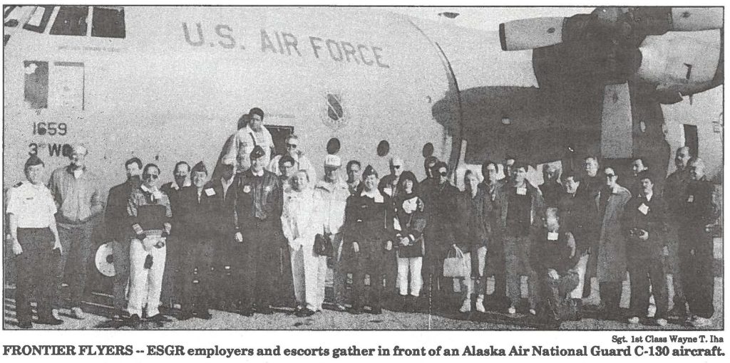 FRONTIER FLYERS --ESGR employers and escorts gather in front of an Alaska Air National Guard C-130 aircraft.