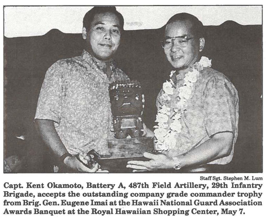 Capt. Kent Okamoto, Battery A, 487th Field Artillery, 29th Infantry Brigade, accepts the outstanding company grade commander trophy from Brig. Gen. Eugene Imai at the Hawaii National Guard Association Awards Banquet at the Royal Hawaiian Shopping Center, May 7.