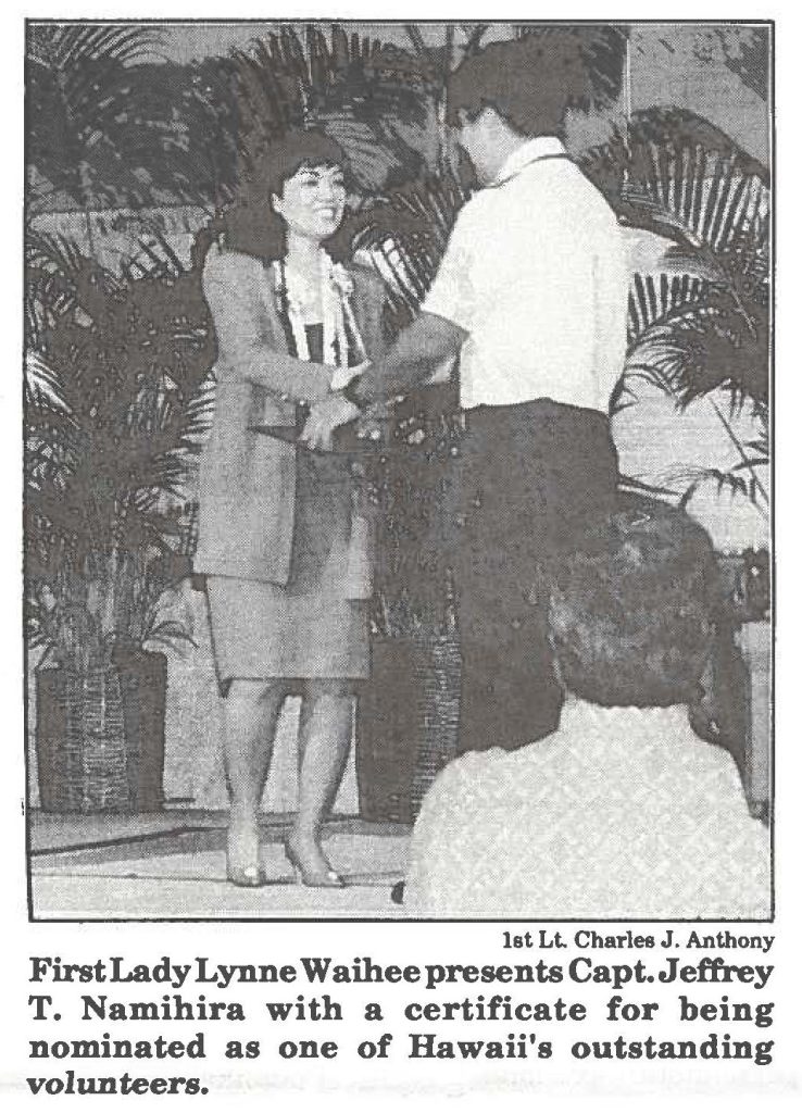 First Lady Lynne Waihee presents Capt. Jeffrey T. Namihira with a certificate for being nominated as one of Hawaii's outstanding volunteers.
