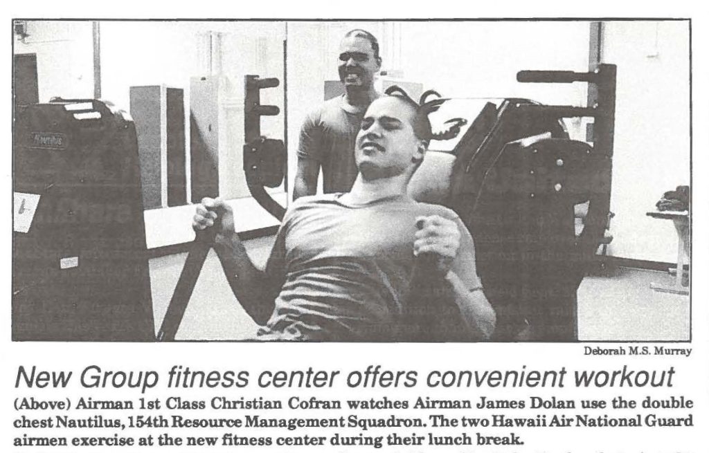 Airman 1st Class Christian Cofran watches Airman James Dolan use the double chest Nautilus, 154th Resource Management Squadron. The two Hawaii.Air National Guard airmen exercise at the new fitness center during their lunch break.