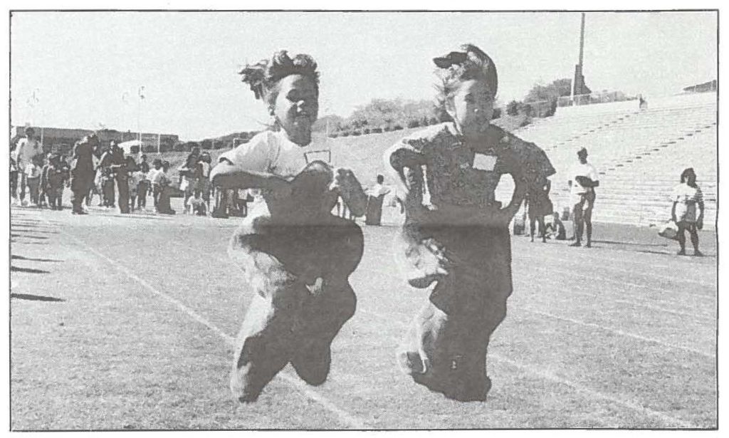 JUMPING BEANS--Two 7-year-olds from Kahului Elementary School jump towards the finish line during the potato sack race at the 14th Annual Superkids competition held at the Maui War Memorial Stadium, Feb. 26. Cherish Paa-Hema (left) and Rynen Rogue (right) were among over 200 children who participated in this event sponsored by the American Lung Association.