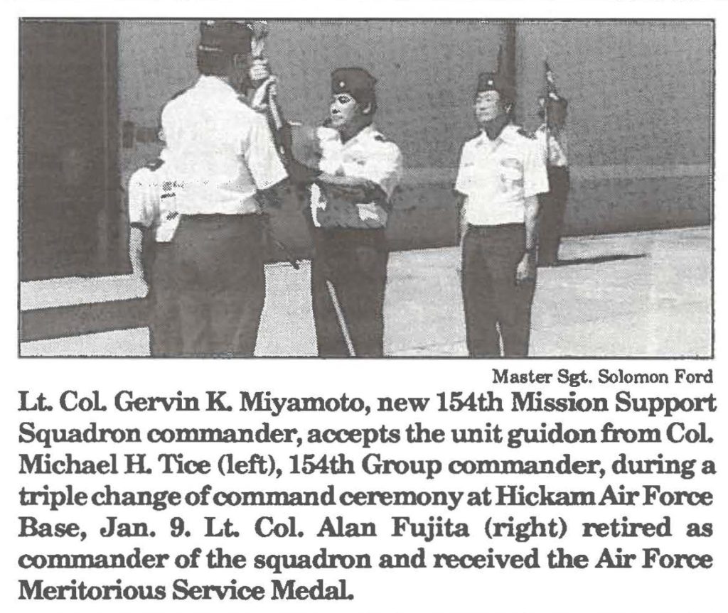 Lt. Col Gervin K. Miyamoto, new 154th Mission Support Squadron commander, accepts the unit guidon from Col Michael H. Tice (left), 154th Group commander, during a triple change of command ceremony at Hickam Air Force Base, Jan. 9. Lt. Col. Alan Fujita (right) retired as commander of the squadron and received the Air Force Meritorious Service Medal.