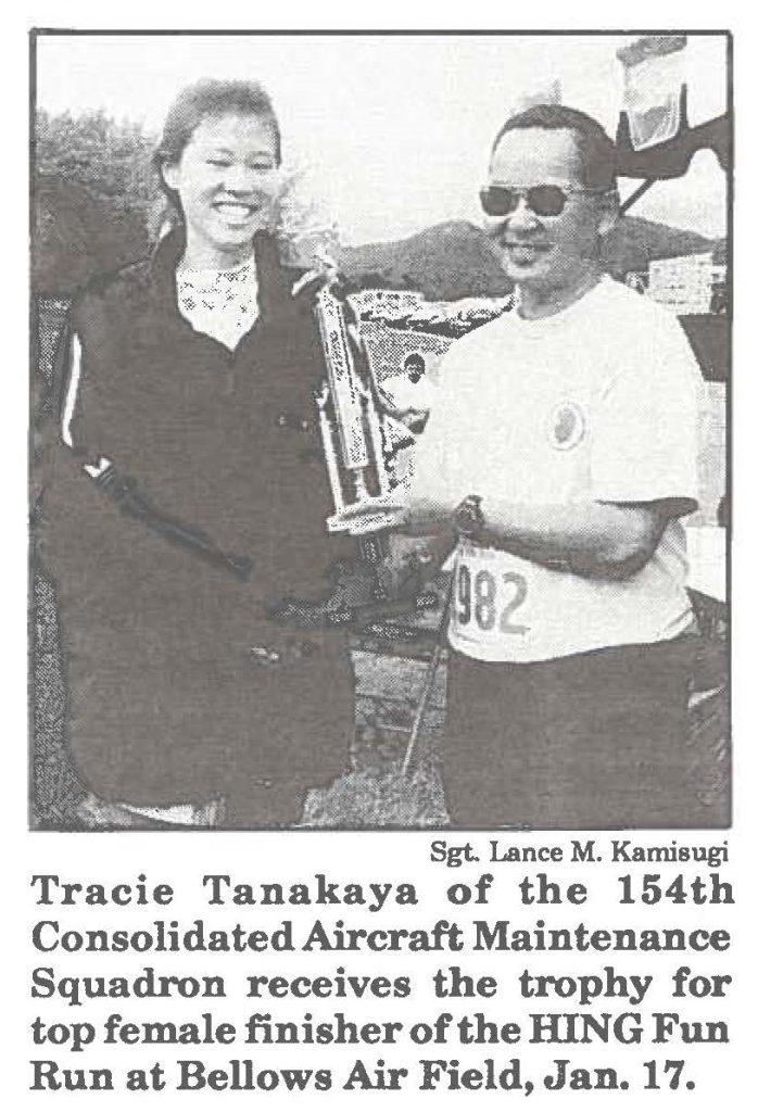 Tracie Tanakaya of the 154th Consolidated Aircraft Maintenance Squadron receives the trophy for top female finisher of the HING Fun Run at Bellows Air Field, Jan. 17.