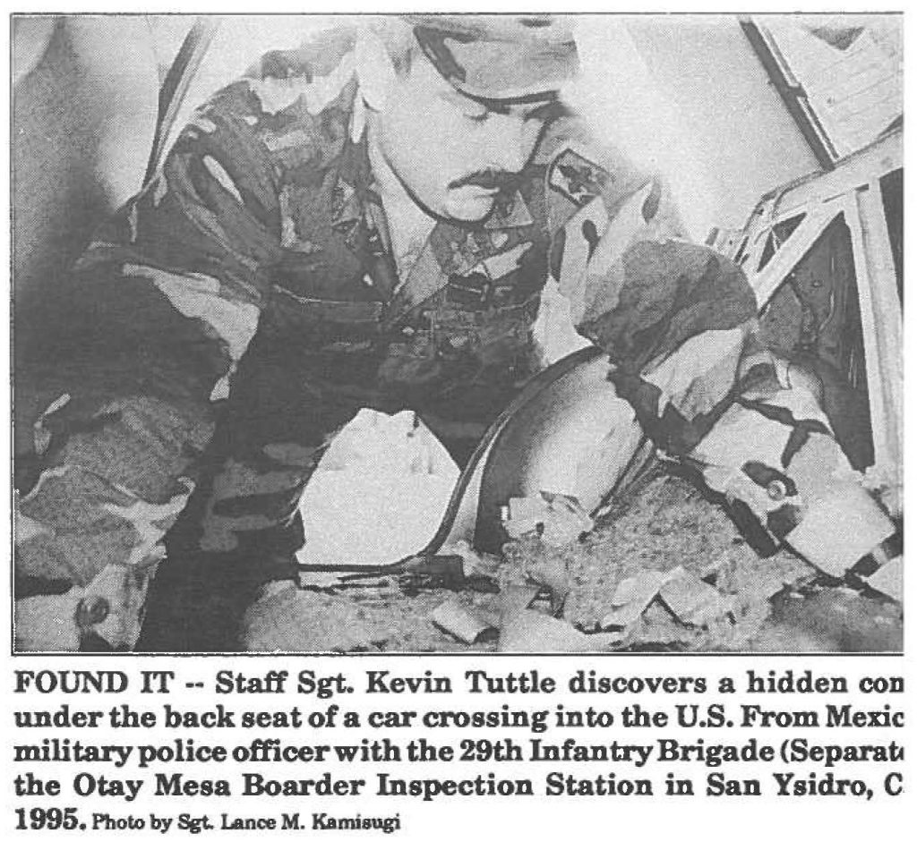 FOUND IT -· Staff Sgt. Kevin Tuttle discovers a hidden compartment under the back seat of a car crossing into the U.S. From Mexico, Tuttle a military police officer with the 29th Infantry Brigade (Separate) trains at the Otay Mesa Boarder Inspection Station in San Ysidro, Calf. June 1995. Photo by Sgt. Lance M. Kamisugi