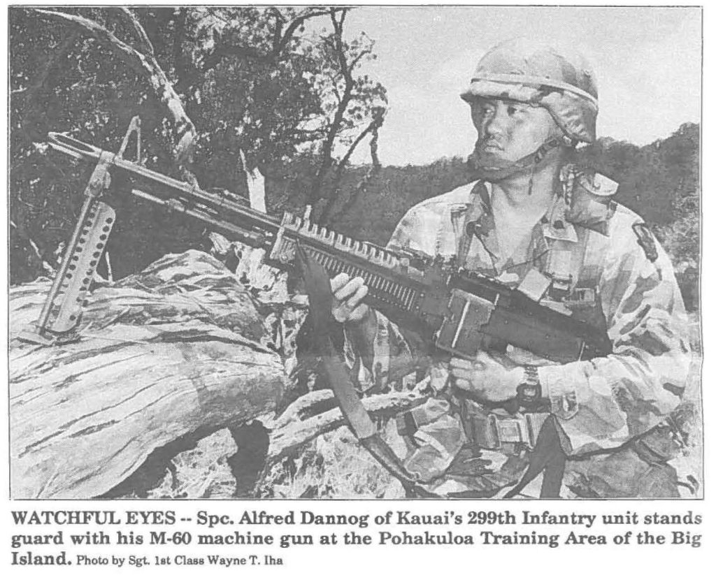 WATCHFUL EYES-- Spc. Alfred Dannog of Kauai's 299th Infantry unit stands guard with his M-60 machine gun at the Pohakuloa Training Area of the Big Island. Photo by Sgt. lat Class Wayne T. Iha