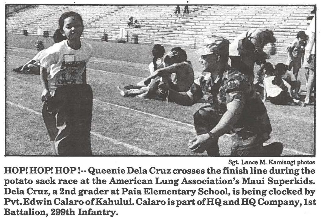 HOP! HOP! HOP!-- Queenie Dela Cruz crosses the finish line during the potato sack race at the American Lung Association's Maui Superkids. Dela Cruz, a 2nd grader at Paia Elementary School, is being clocked by Pvt. Edwin Calaro of Kahului. Calaro is part of HQ and HQ Company, 1st Battalion, 299th Infantry.