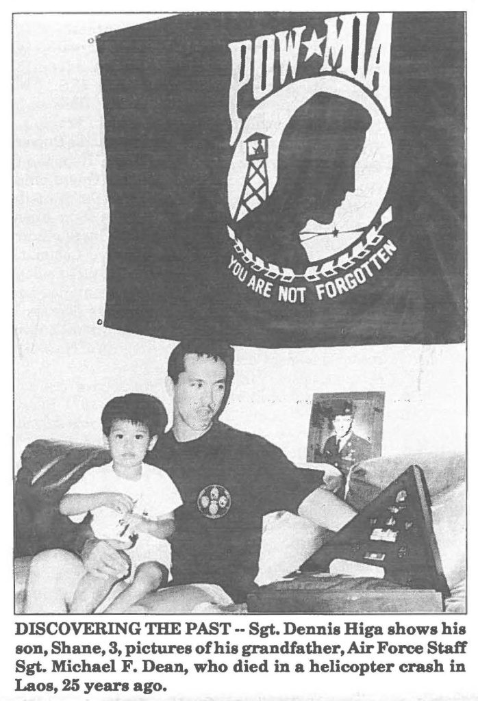 DISCOVERING THE PAST-- Sgt. Dennis Higa shows his son, Shane, 3, pictures of his grandfather, Air Force Staff Sgt. Michael F. Dean, who died in a helicopter crash in Laos, 25 years ago.