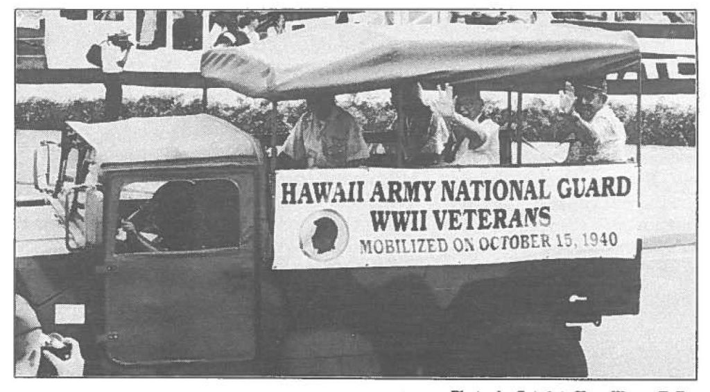 THIS ONES FOR YOU -- Hawaii Army National Guard World War II veterans wave to the crowd at Saturday's parade.