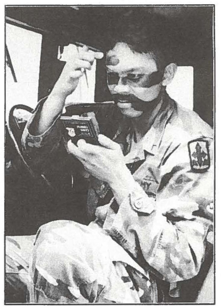 Pvt. Marlon Bermudez of Keaau applies camouflage face paint prior to going on an operation with Hilo's Headquarters and Headquarters Company 2nd Battalion, 299th Infantry Bermudez a medic and student at Hilo Community College, is among the Hawaii Army National Guard soldiers who performed annual training in late May. -- Sgt. 1st Class Wayne Iha, 117th Public Affairs Team