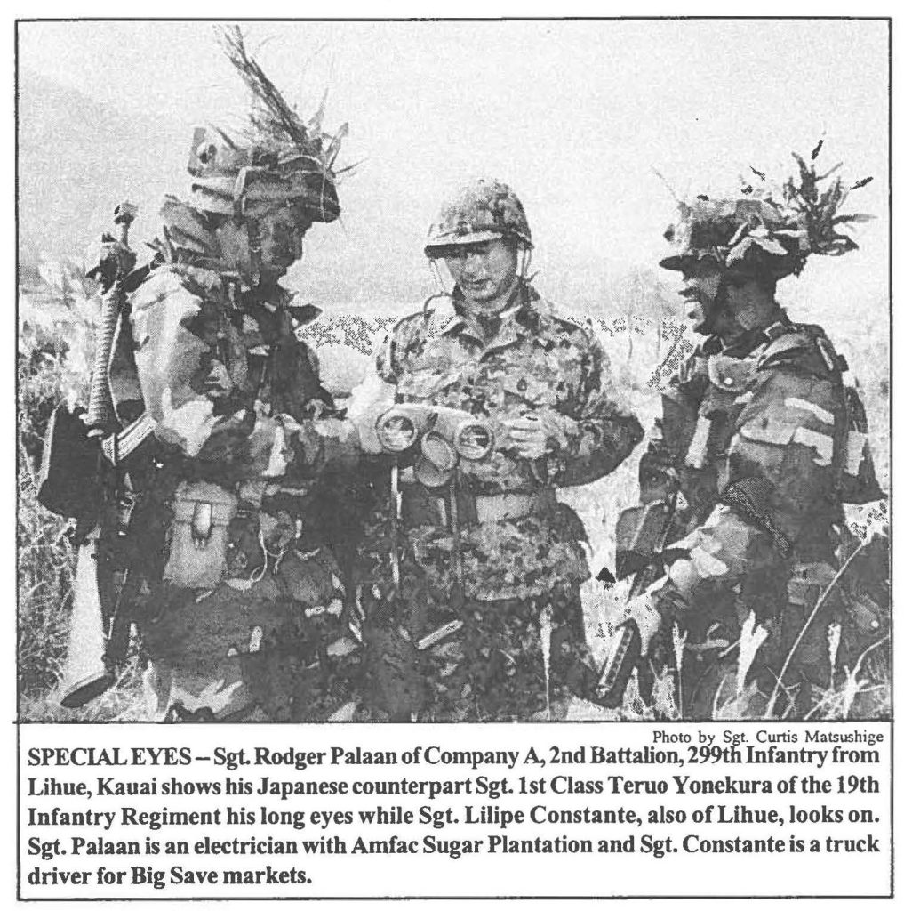 SPECIAL EYES- Sgt. Rodger Palaan of Company A, 2nd Battalion, 299th Infantry from Lihue, Kauai shows his Japanese counterpart Sgt.1st Class Teruo Yonekura of the 19th Infantry Regiment his long eyes while Sgt. Lilipe Constante, also of Lihue, looks on. Sgt. Palaan is an electrician with Amfac Sugar Plantation and Sgt. Constante is a truck driver for Big Save markets.
