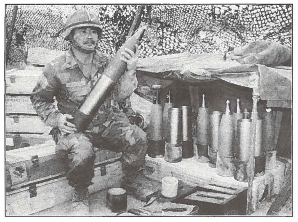AMMO MAN - Sgt. Curtis Miyashiro, a member of Charlie Battery of the 1st Battlaion, 487th Infantry, readies another 105 mm HE round for his gun crew. Miyashiro is one of 240 Hawaii Army National Guard soldiers participating in annual training exercises at the Yakima Training Center in Washington State.