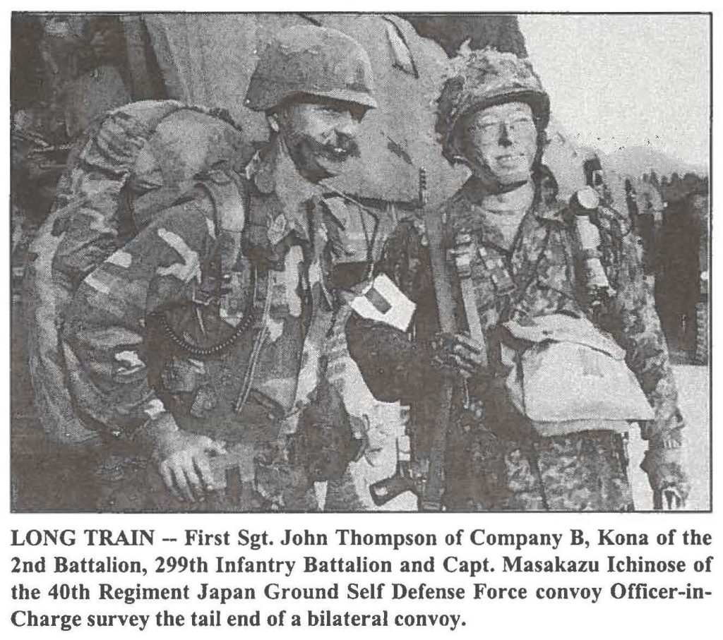 LONG TRAIN -- First Sgt. John Thompson of Company B, Kona of the 2nd Battalion, 299th Infantry Battalion and Capt. Masakazu Ichinose of the 40th Regiment Japan Ground Self Defense Force convoy Officer-in-Charge survey the tail end of a bilateral convoy.