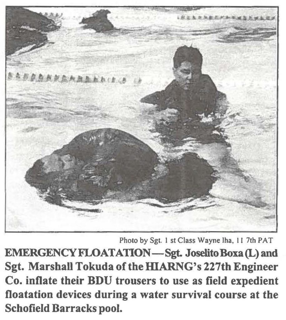 EMERGENCY FLOATATION-Sgt. Joselito Boxa (L) and Sgt. Marshall Tokuda of the HlARNG's 227th Engineer Co. inflate their BDU trousers to use as field expedient floatation devices during a water survival course at the Schofield Barracks pool.