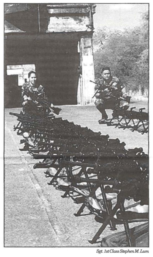 THEY CAME, THEY SAW, THEY ASSEMBLED - Sgts. Kimberly T. Christopherson and Ronald Butta Jr. help to assemble and distribute the more than 240 new squad automatic weapons (SAW) fielded to the Hawaii Army National Guard in October. The Hawaii Guard received their shipment the same time as the active component's 25th Infantry Division (Light).
