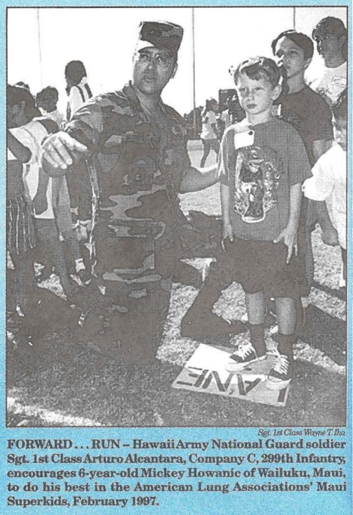 FORWARD . . . RUN - Hawaii Army National Guard solider Sgt. 1st Class Arturo Alcantara, Company C, 299th Infantry, encourages 6-year-old Mickey Howanic of Wailuku, Maui, to do his best in the American Lung Associations' Maui Superkids, February 1997