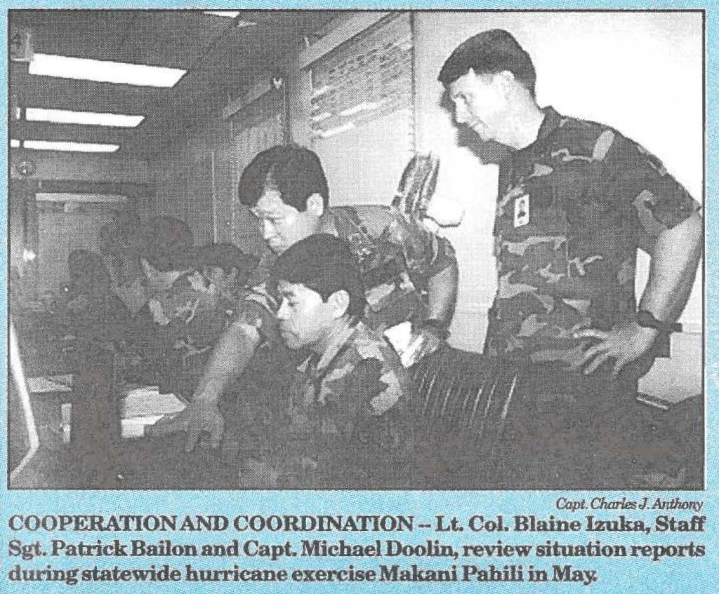 COOPERATION AND COORDINATION -- Lt. Col. Blaine Izuka, Staff Sgt. Patrick Bailon and Capt. Michael Doolin, review situation reports during statewide hurricane exercise Makani Pahili in May.