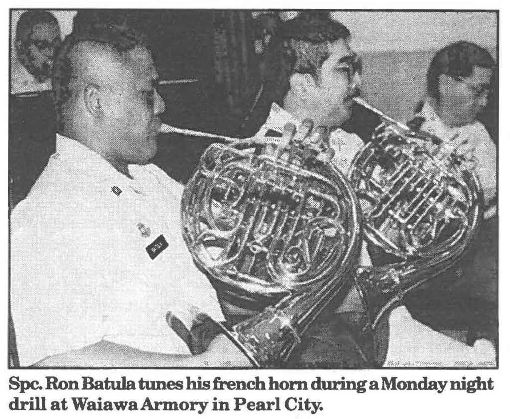 Spc. Ron Batula tunes his french horn during a Monday night drill at Waiawa Armory in Pearl City.