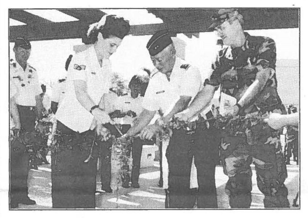 Senior Airman Dawn Wahinekapu, Maj. Gen. Edward V. Richardson, state adjutant general and Col. Richard Hastings, 154th Support Group commander, untie the maile lei, symbolically opening the Consolidated Support Facility at Hickam Air Force Base, Feb. 9