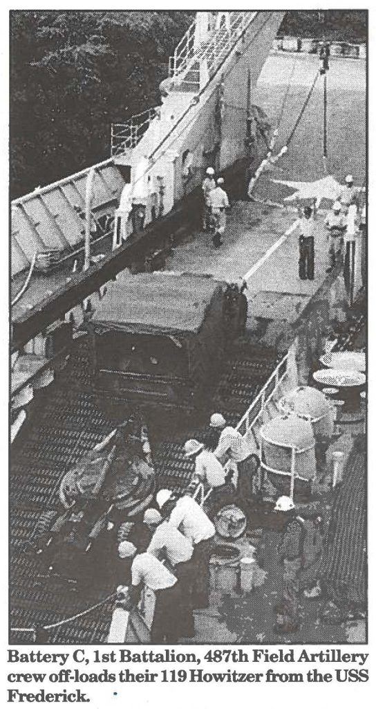 Battery C, 1st Battalion, 487th Field Artillery crew off-loads their 119 Howitzer from the USS Frederick.