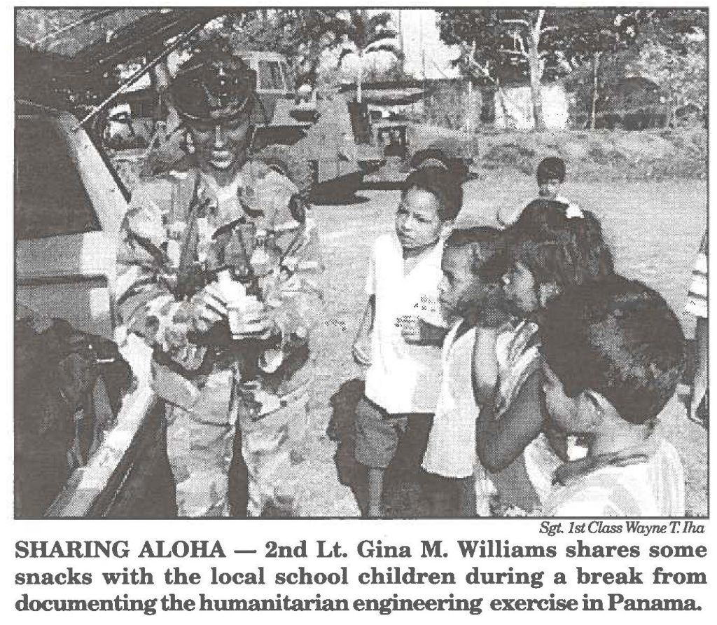 SHARING ALOHA - 2nd Lt. Gina M. Williams shares some snacks with the local school children during a break from documenting the humanitarian engineering exercise in Panama.