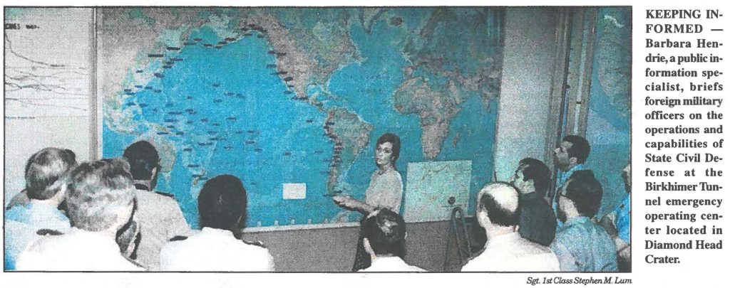 KEEPING INFORMED - Barbara Hendrie, a public information specialist, briefs foreign military officers on the operations and capabilities of State Civil Defense at the Birkhimer Tunnel emergency operating center located in Diamond Head Crater.