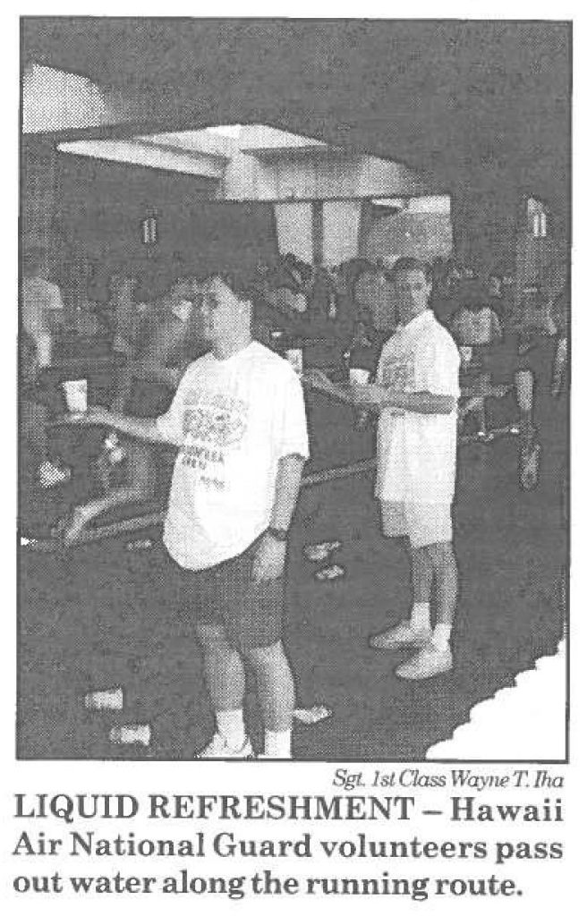 LIQUID REFRESHMENT- Hawaii Air National Guard volunteers pass out water along the running route.