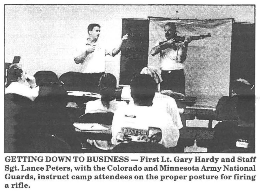 GETTING DOWN TO BUSINESS - First Lt. Gary Hardy and Staff Sgt. Lance Peters, with the Colorado and Minnesota Army National Guards, instruct camp attendees on the proper posture for firing a rifle.