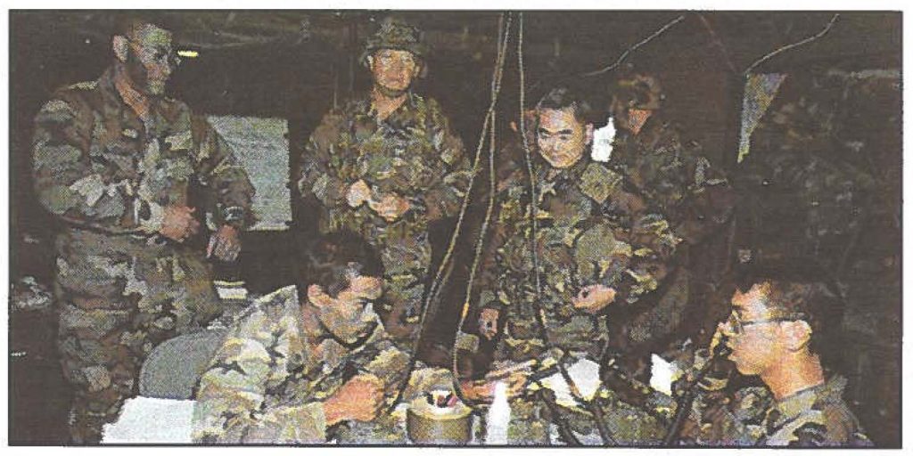 BIG BANG - Maj. Gen. Edward L. Correa Jr., the
adjutant general, and State Command Sgt. Maj. Vernon A Nakasone, visit with the soldiers of 1st Battalion, 487th Field Artillery, at Pohakuloa Training Area, in August. 