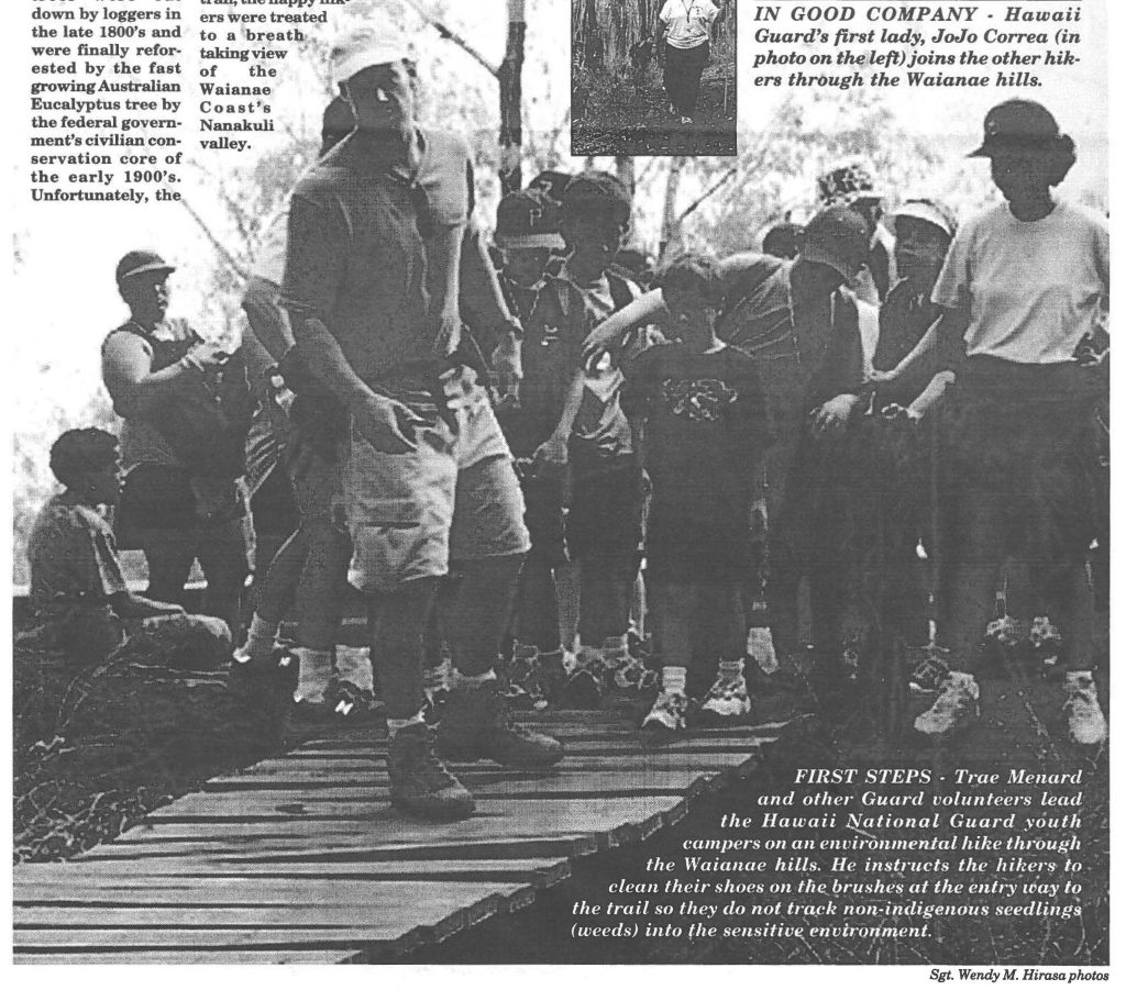 FIRST STEPS - Trae Menard and other Guard volunteers lead the Hawaii National Guard youth campers on an environmental hike through the Waianae hills. He instructs the hikers to clean their shoes on the brushes at the entry way to the trail so they do not track non-indigenous seedlings (weeds) into the sensitive environment.