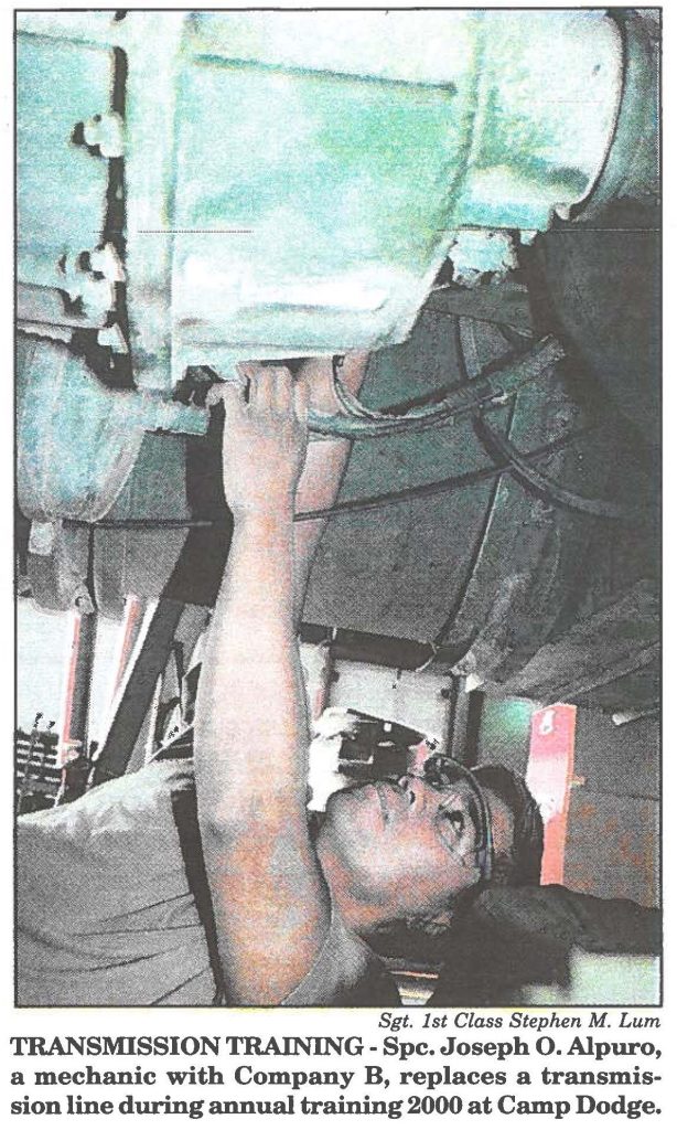 TRANSMISSION TRAINING - Spc. Joseph O. Alpuro, a mechanic with Company B, replaces a transmission line during annual training 2000 at Camp Dodge.
