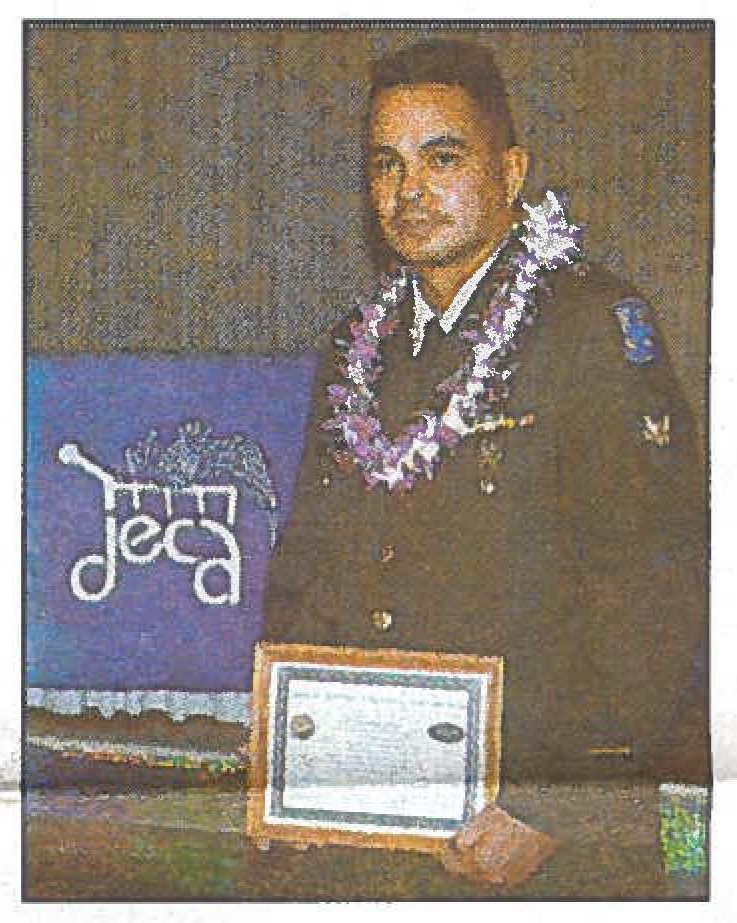 GUARD MEMBERSHlP PAYS OFF Spc. Jonathan J. Knox accepts a Defense Commissary Agency / Hawaiian Isles Kona Coffee scholarship which will go toward his nursing degree tuition. Sgt. 1st Class Stephen M. Lum photo