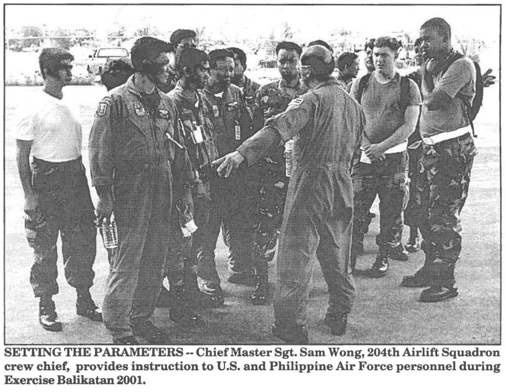 SETTING THE PARAMETERS·-Chief Master Sgt. Sam Wong, 204th Airlift Squadron crew chief, provides instruction to U.S. and Philippine Air Force personnel during Exercise Balikatan 2001.
