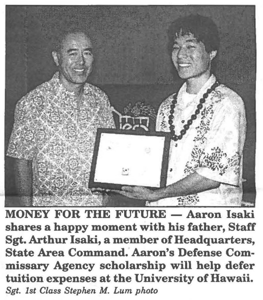 MONEY FOR THE FUTURE - Aaron Isaki shares a happy moment with his father, Staff Sgt. Arthur Isaki, a member of Headquarters, State Area Command. Aaron's Defense Commissary Agency scholarship will help defer tuition expenses at the University of Hawaii. Sgt. 1st Class Stephen M. Lum photo