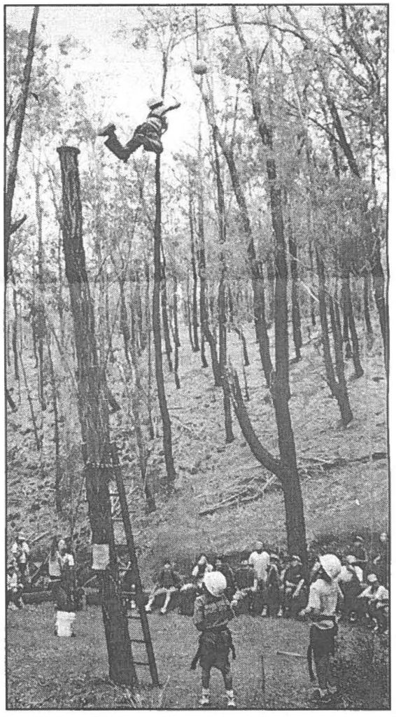 CROUCHING TIGER - A youth moves through the trees with safety harness in the high rope activity open only to the 11-14 year-olds.