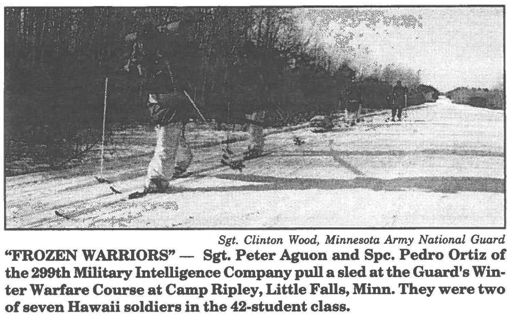 "FROZEN WARRIORS" - Sgt. Peter Aguon and Spc. Pedro Ortiz of the 299th Military Intelligence Company pull a sled at the Guard's Winter Warfare Course at Camp Ripley, Little Falls, Minn. They were two of seven Hawaii soldiers in the 42-student class.