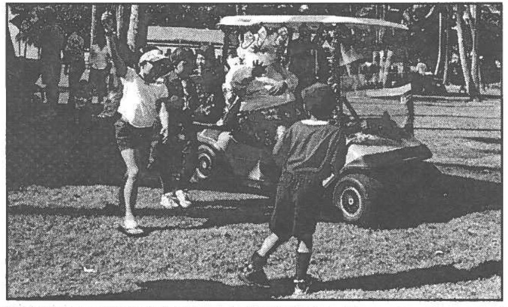 HAWAIIAN CHRISTMAS CELEBRATION - Hawaiian Santa's grand entrance via golf "sleigh" lead by "reindeer" began the 2001 Hawaii National Guard Christmas concert featuring the 111th Army Band. Sgt Wendy M. Hirasa photo