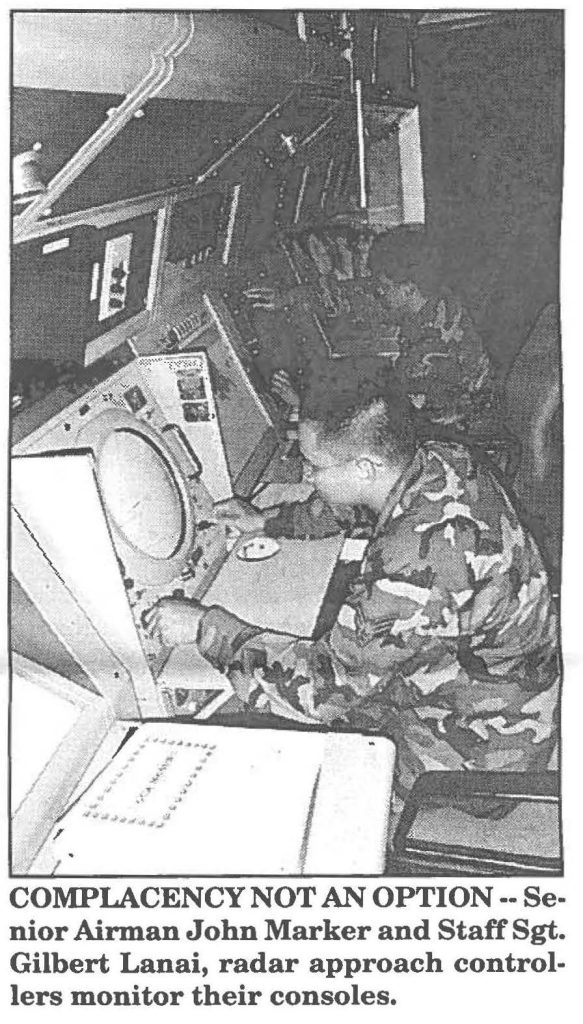 COMPLACENCY NOT AN OPTION -- Senior Airman John Marker and Staff Sgt. Gilbert Lanai, radar approach controllers monitor their consoles.