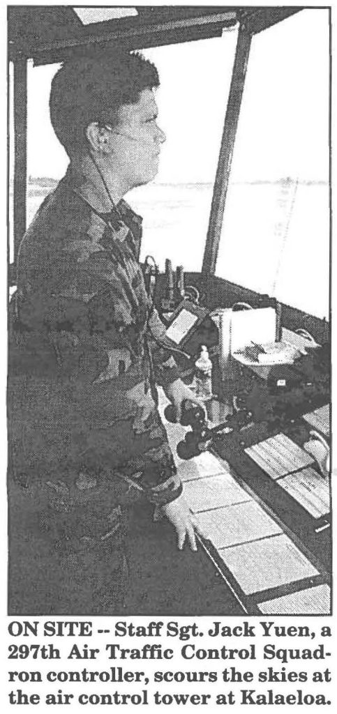 ON SITE -- Staff Sgt. Jack Yuen, a 297th Air Traffic Control Squadron controller, scours the skies at the air control tower at Kalaeloa.
