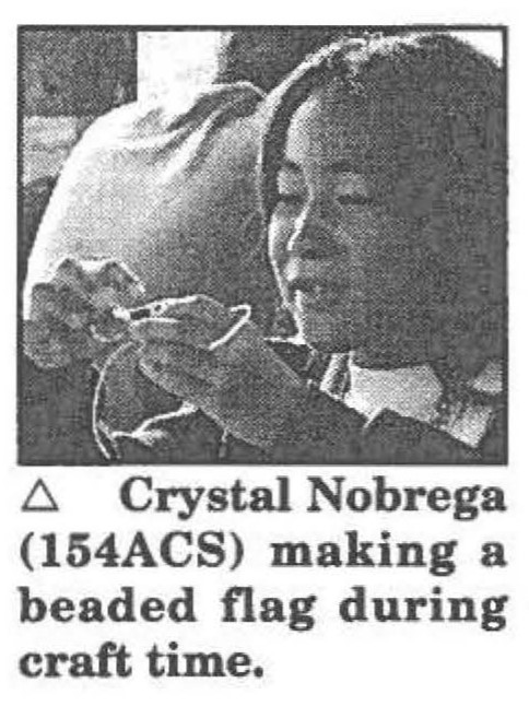 Crystal Nobrega (154ACS) making a beaded flag during craft time.