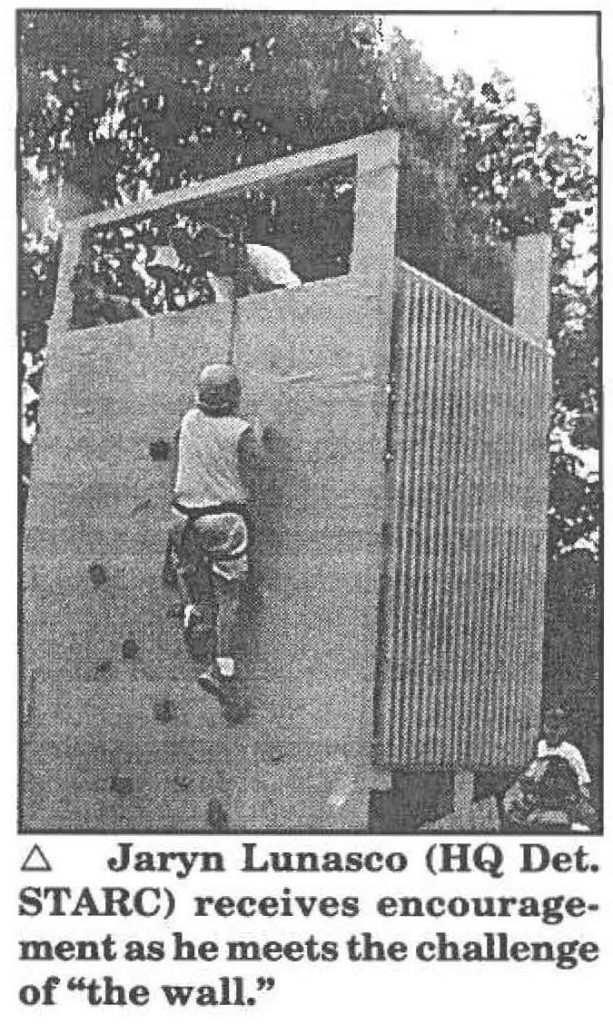 Jaryn Lunasco (HQ Det. STARC) receives encouragement as he meets the challenge of "the wall."