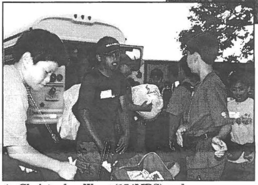 Christopher Wong (lSOIDS) and Kenyatta Muhammad (D/2-299IN) help other HlNG youth off-load the buses at Camp Timberline.