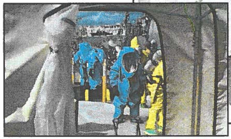 NAVALRECON-93rd Civil Support Team reconnaissance personnel probe the laundry room of the USS Hopper for the traces decontaminates at the Pearl Harbor dock and later rinse off on-shore.